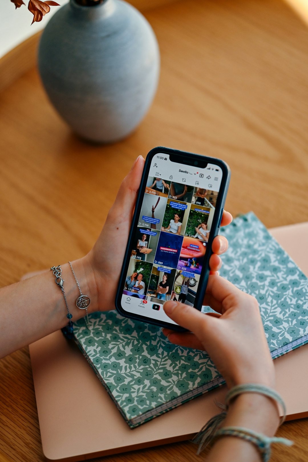 hands-holding-smartphone-displaying-social-media-feed-utjxtrandy
